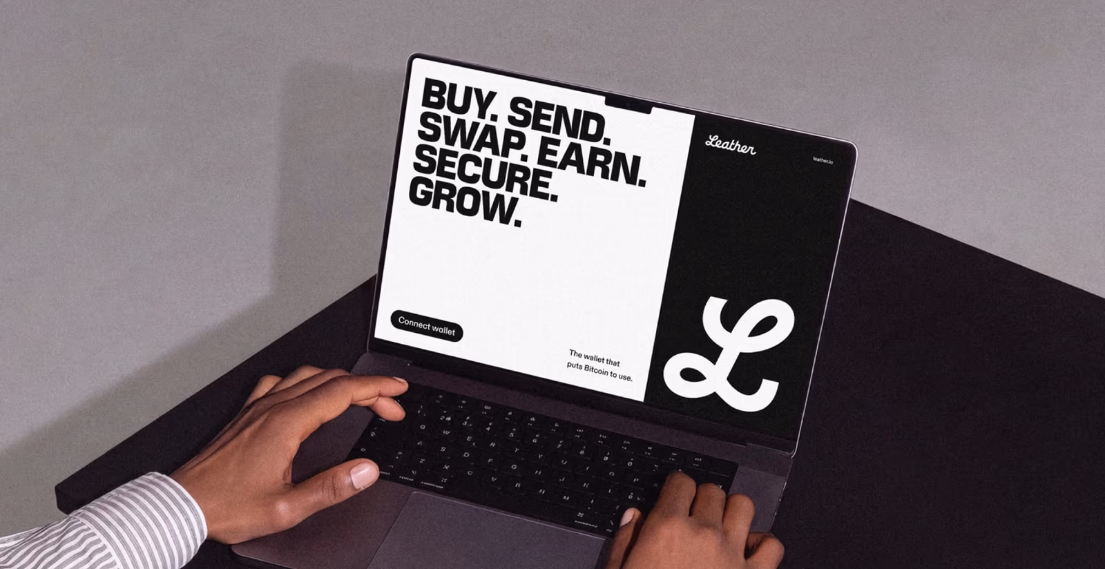 Hands on a laptop showing Leather's site: the headline Buy, send, swap, earn, secure, grow beside the L monogram on black